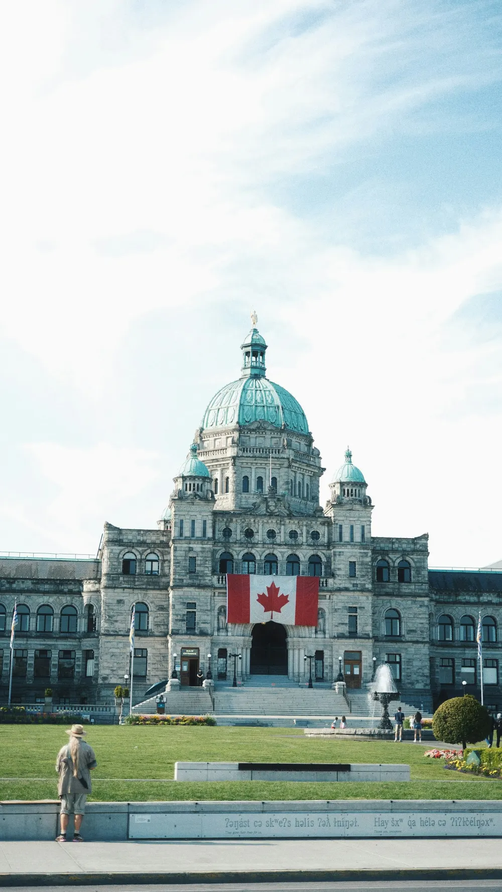 The BC Parliament Buildings with the Canadian flag